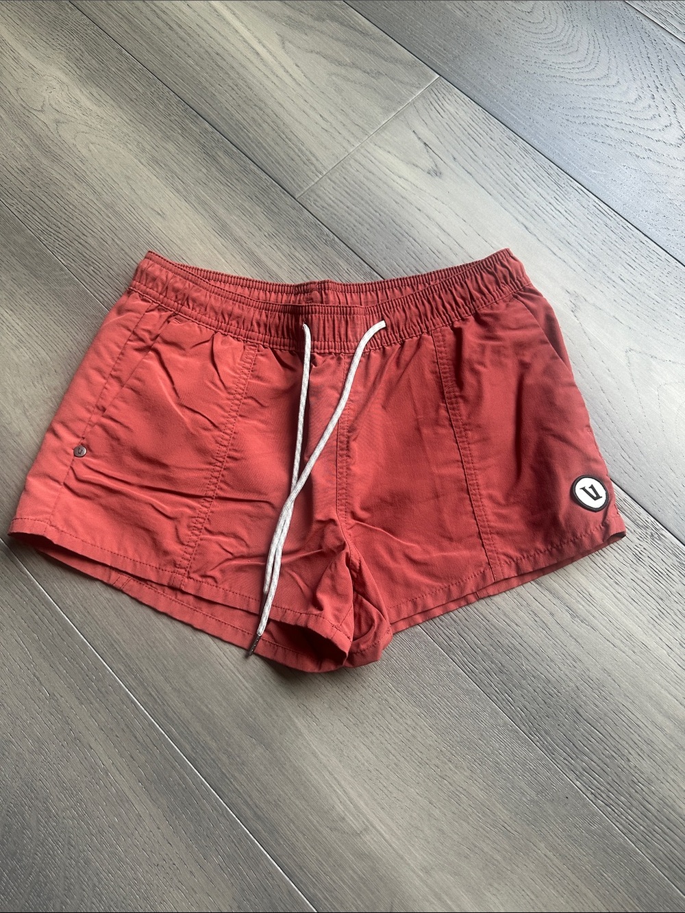 Vuori Women's Athletic Shorts in Brick Red